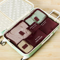 Set of six wine-red travel packing organisers