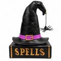 Halloween witch hat and spell book resin figurine