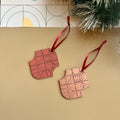 Geometric wooden Christmas ornaments in copper and winter berry designs